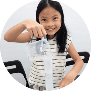 A student pouring water into a a long plastic beaker to measure volume