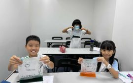 . students holding up their experiment
